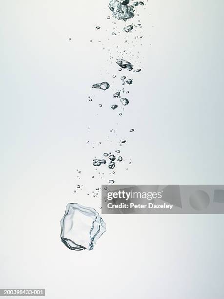 ice cube and bubbles in water - bubbles stock pictures, royalty-free photos & images