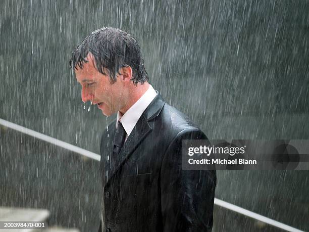 businessman walking up steps in rain, profile, close-up - drenched stock pictures, royalty-free photos & images