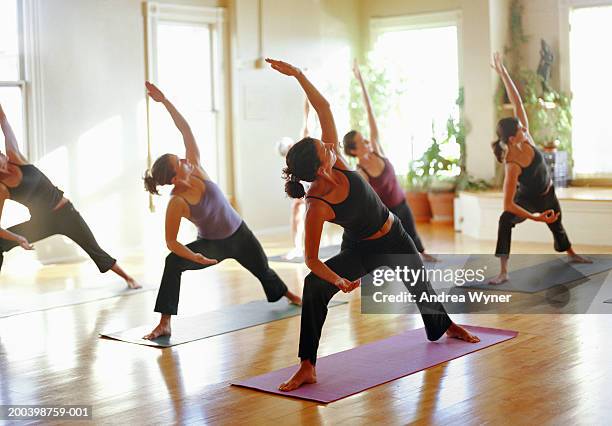 group of women stretching in yoga class, arms raised - exercise class fotografías e imágenes de stock