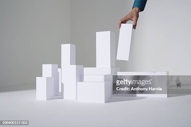 man building white blocks, close-up - block ストックフォトと画像