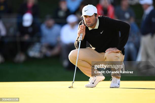 Scottie Scheffler of the United States lines up a putt on the 18th green during the final round of the WM Phoenix Open at TPC Scottsdale on February...