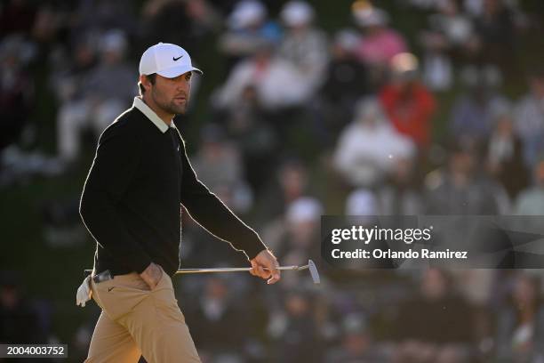 Scottie Scheffler of the United States walks across the 18th green during the final round of the WM Phoenix Open at TPC Scottsdale on February 11,...