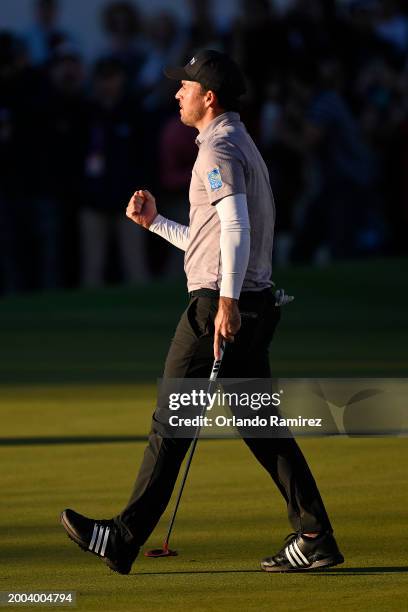 Nick Taylor of Canada celebrates making his putt on the 18th green to tie for the lead and force a playoff during the final round of the WM Phoenix...