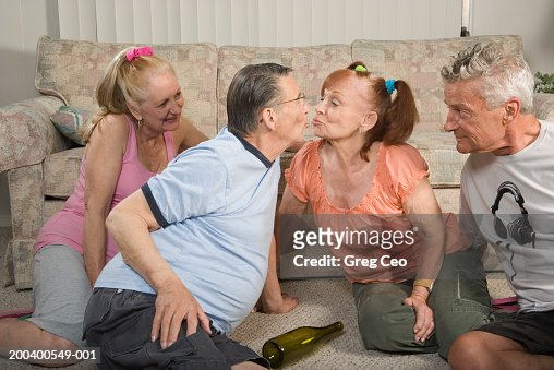 Senior Couples Playing Spin The Bottle Side View Closeup High Res Stock 