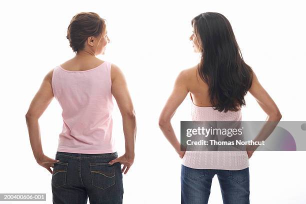 young woman and mature woman standing with hands on hips, rear view - tank top back stock pictures, royalty-free photos & images