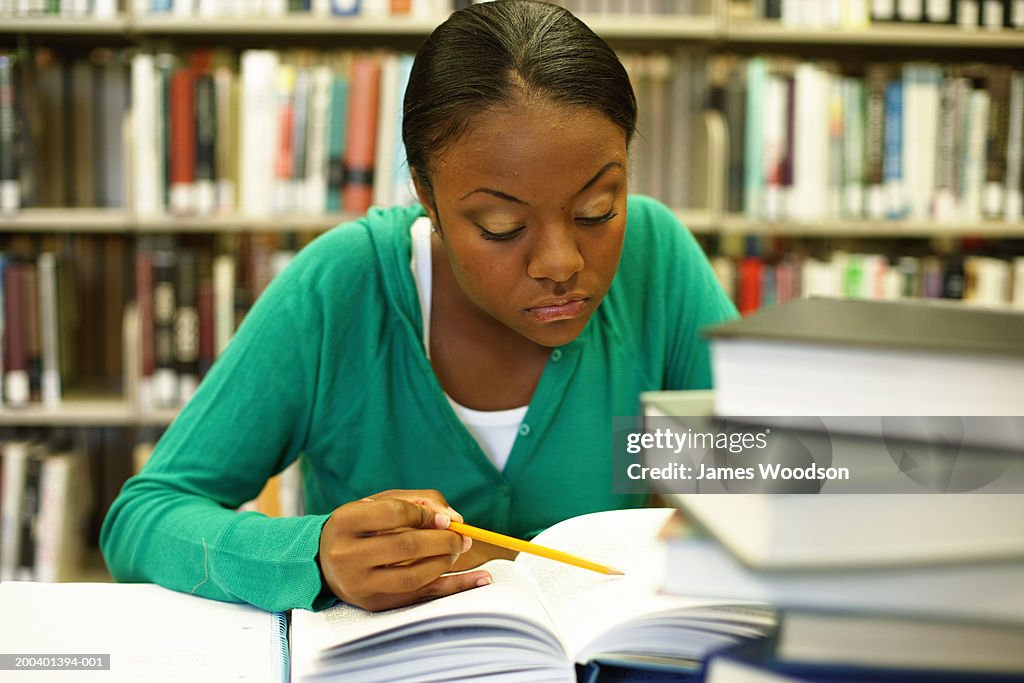 Female college student studying in library