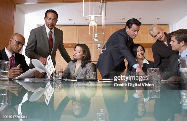 group of business people conversing in conference room, view across table - office politics stock pictures, royalty-free photos & images