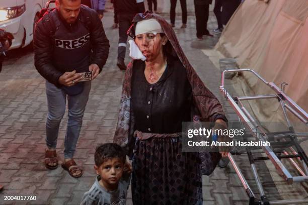 Injured Palestinians arrive at Kuwait Hospital after Israeli air strikes on February 12, 2024 in Rafah, Gaza. Strikes intensified overnight as Israel...