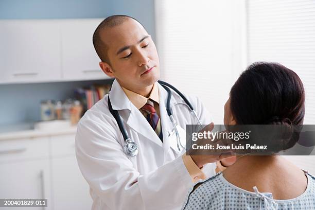 doctor examining female patient - throat exam stock pictures, royalty-free photos & images