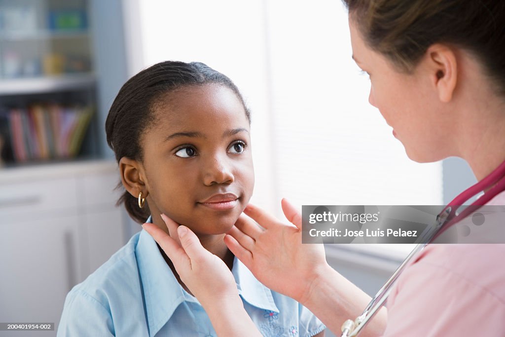 Nurse examining girl (8-10)
