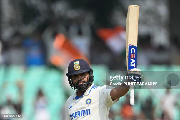 India's captain Rohit Sharma raises his bat after scoring a century during the first day of the third Test cricket match between India and England at...