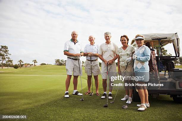 group of senior golfers on golf course, smiling, portrait - senior men golf stock pictures, royalty-free photos & images