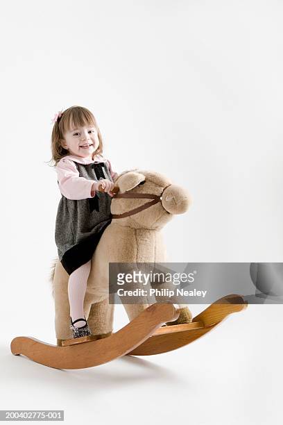 toddler girl (21-24months) smiling on rocking horse, portrait - one baby girl only bildbanksfoton och bilder