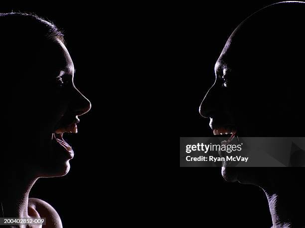 man and young woman looking at one another, laughing, profile - mouth open profile stock pictures, royalty-free photos & images