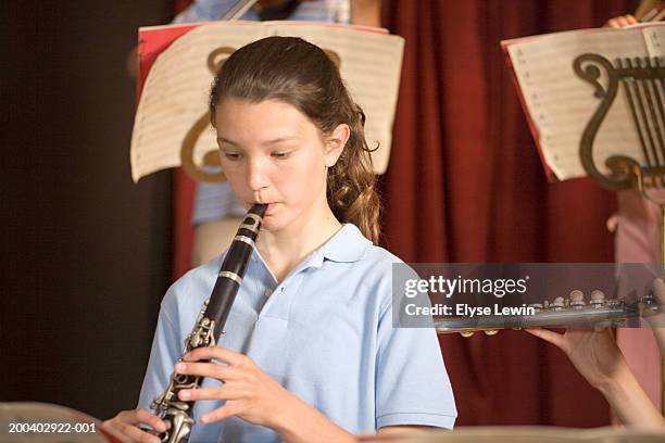 girl (11-13) playing flute in school band - flöte stock-fotos und bilder