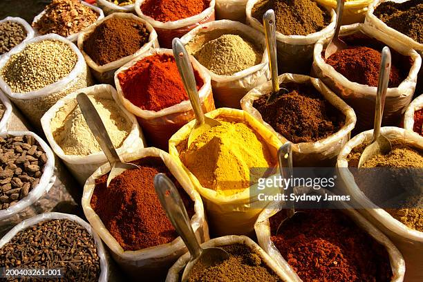spices in containers at market - spezia foto e immagini stock