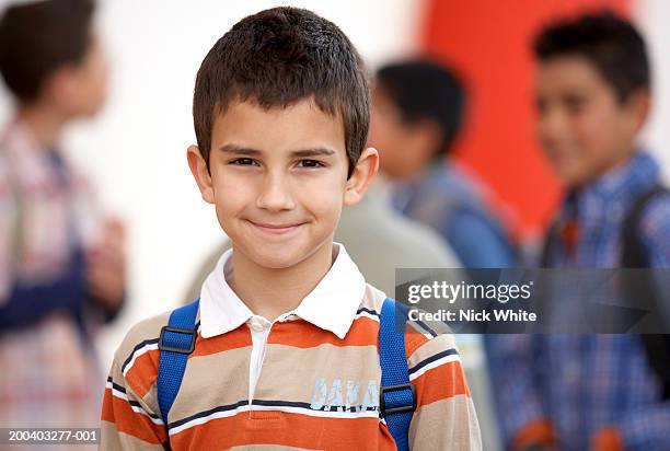 boy (8-10) wearing rucksack, smiling, portrait, close-up - boy 10 11 stock pictures, royalty-free photos & images