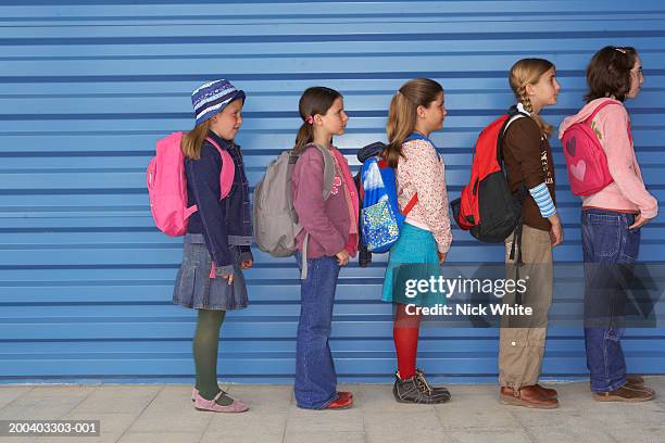 group of girls (8-11) queuing along wall, side view - kids lining up stock pictures, royalty-free photos & images