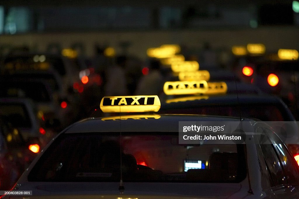 Row of illuminated taxis