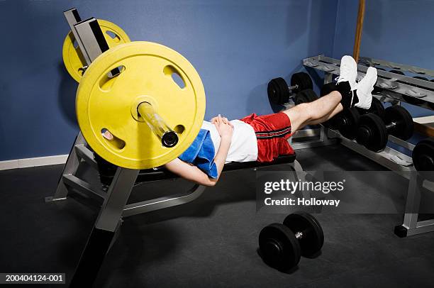 man lying on bench press, face obscured by wheel - running shorts stock pictures, royalty-free photos & images