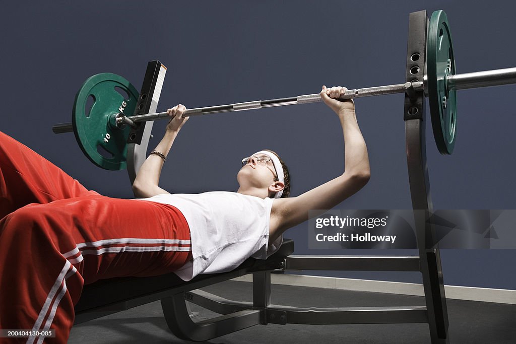 Young man about to lift weight in gym