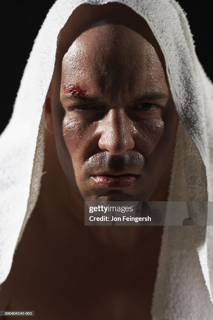Boxer wearing towel over head, portrait