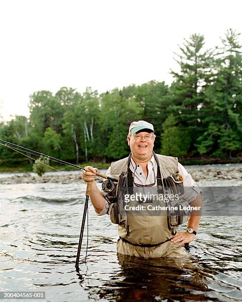 fly fisherman standing in river - waders imagens e fotografias de stock