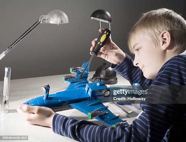 boy (11-13) building model aeroplane, smiling - model kit fotografías e imágenes de stock