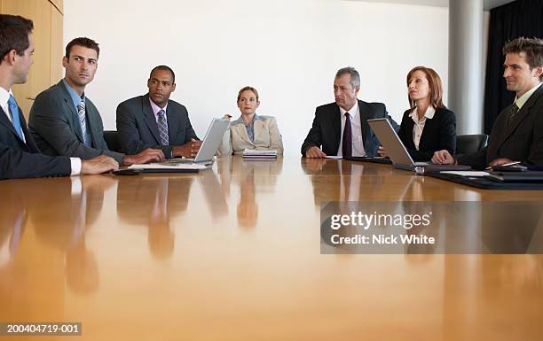 business people having meeting in conference room, view across table - business people group brown stock pictures, royalty-free photos & images