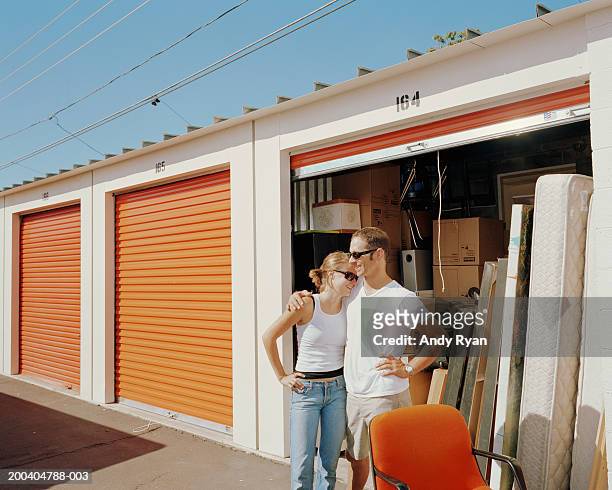 couple in front of storage shed, man's arm around woman - storage compartment ストックフォトと画像