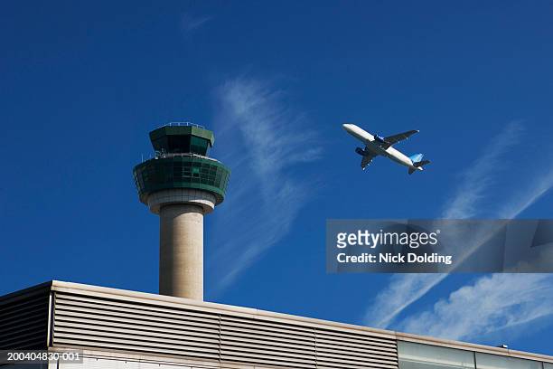 plane in air above airport - stansted airport stock-fotos und bilder