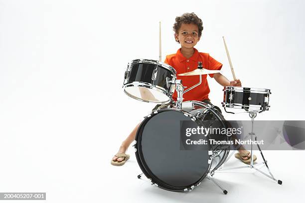 boy (4-6) playing drums, smiling, portrait - african drum stock pictures, royalty-free photos & images