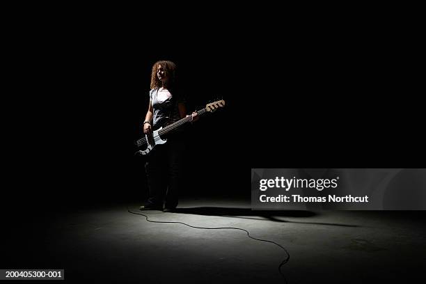teenage girl (13-15) playing bass guitar - bass gitarre stock-fotos und bilder