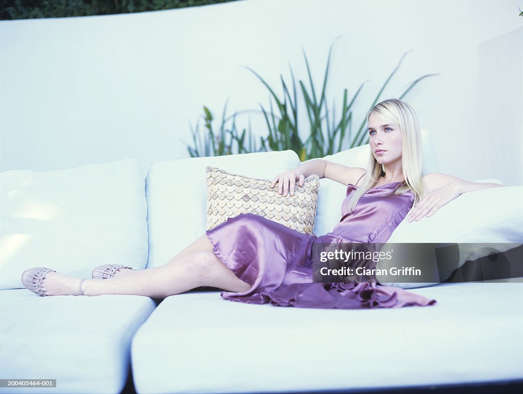 Young woman reclining on sofa