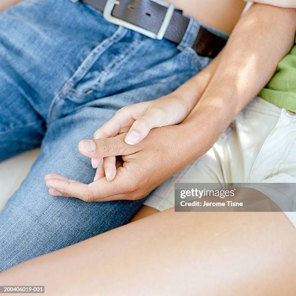 young couple in hammock holding hands, low section, close-up - male crotch 個照片及圖片檔