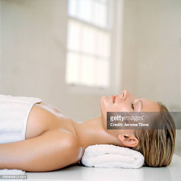 young woman wearing beauty treatment on face and body, side view - face pack stock pictures, royalty-free photos & images
