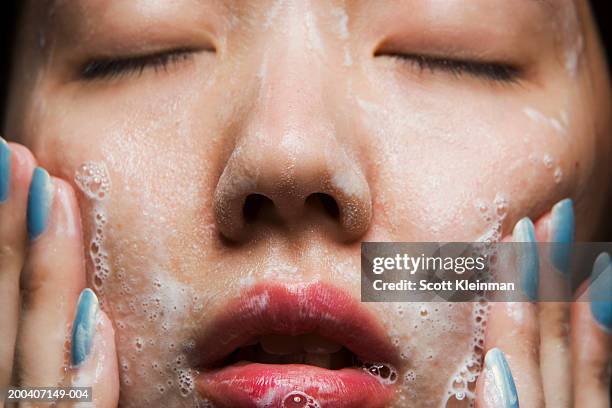 young woman washing face, close-up - woman face cleaning photos et images de collection