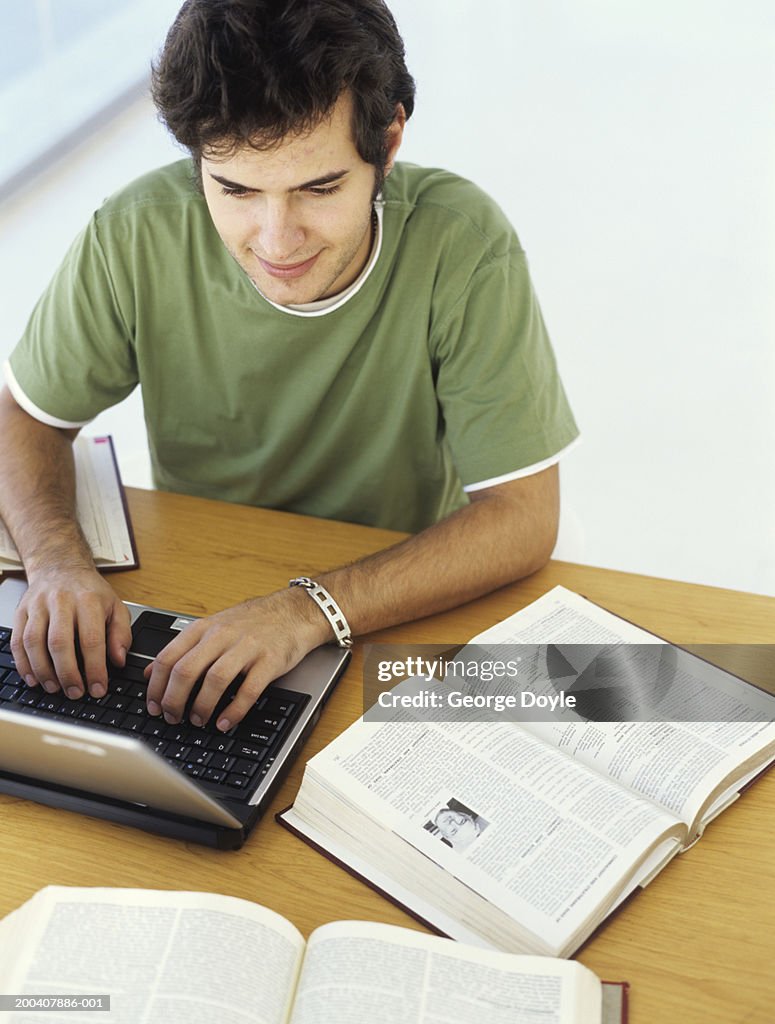Young man using laptop, elevated view