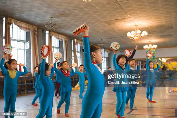 children (6-8)  practicing in folk dance class, side view - school auditorium stock pictures, royalty-free photos & images