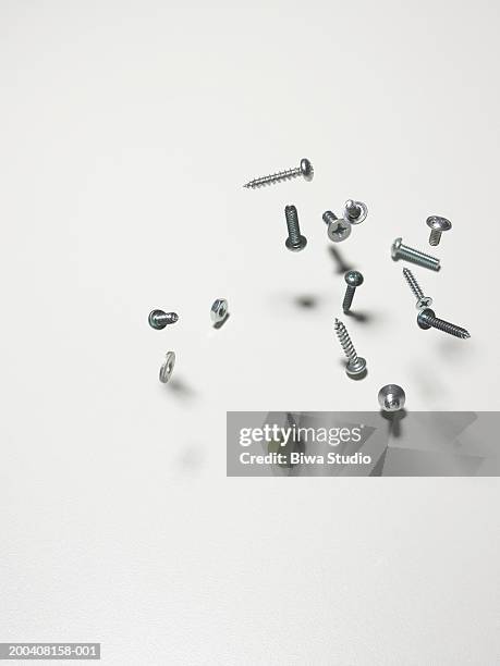 screws, nuts and bolts bouncing on counter, close-up - bout stockfoto's en -beelden