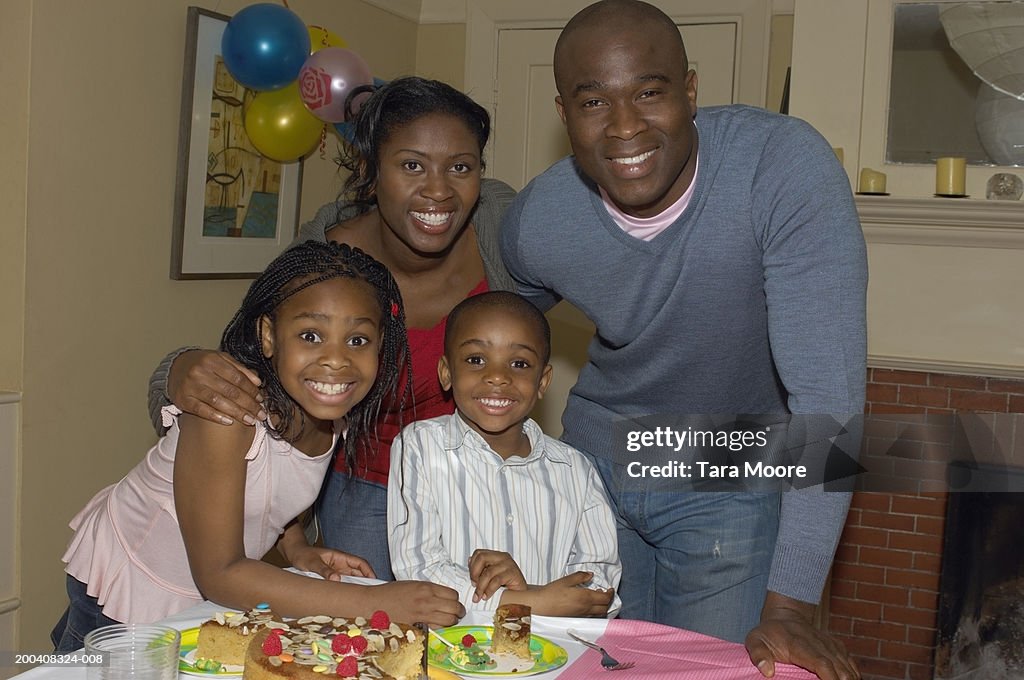 Parents and children (4-7) celebrating birthday, smiling, portrait