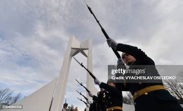 Kyrgyz soldiers fire a salute at a memorial monument to the Soviet soldiers killed in Afghanistan while fighting against the Afghan rebels in the...