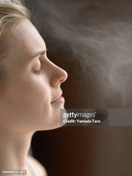 woman with eyes closed, side view - perfume sprayer bildbanksfoton och bilder