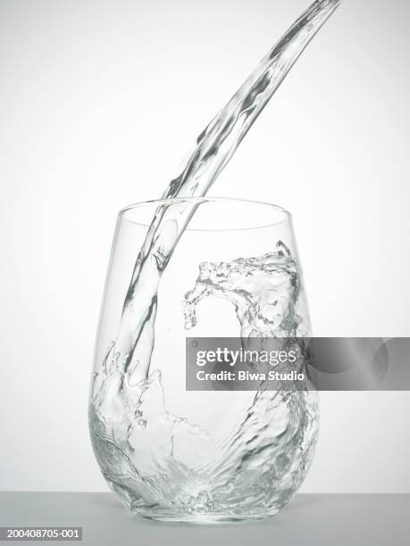 water being poured into glass, close-up - drinking glass water stock pictures, royalty-free photos & images