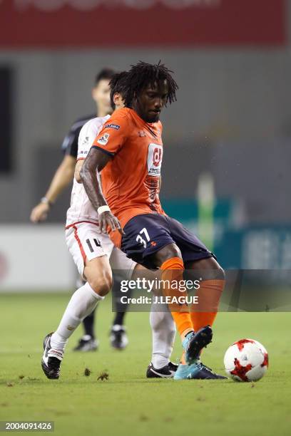 Caue of Omiya Ardija controls the ball against Yoshiki Takahashi of Sagan Tosu during the J.League J1 match between Sagan Tosu and Omiya Ardija at...