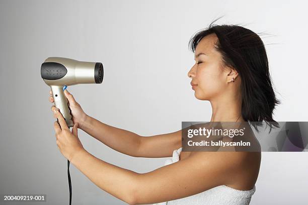 woman blow drying hair in bath towel - hot korean women stock pictures, royalty-free photos & images