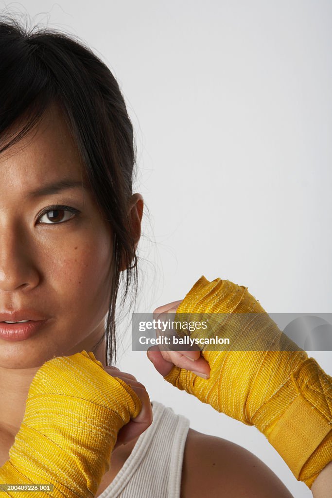 Woman wearing boxing wraps, portrait