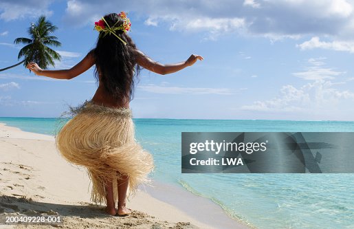 Native dancer on beach, rear view Native dancer on beach, rear view