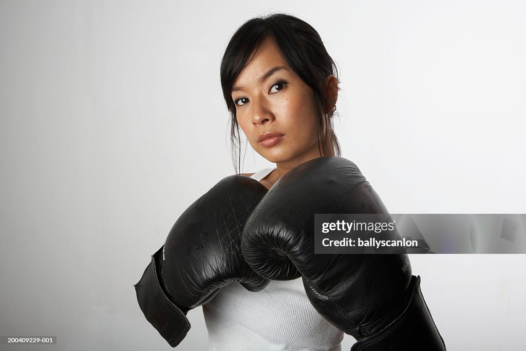 Woman with boxing gloves, portrait
