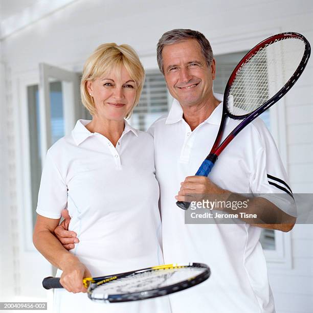 mature couple in tennis outfits smiling, portrait - atuendo de tenis fotografías e imágenes de stock